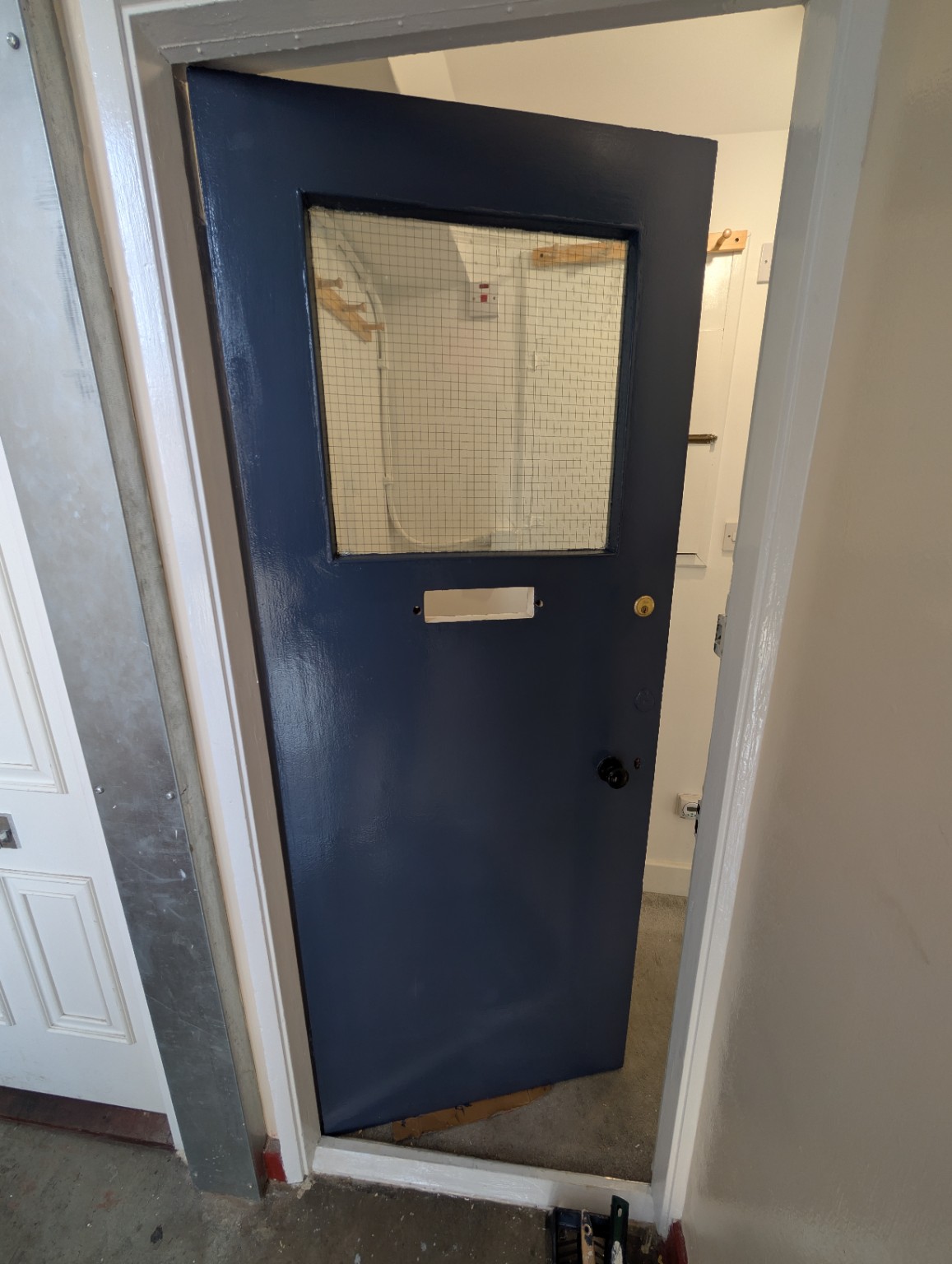 Door repainted in a deep navy finish by OP Property Services